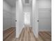 Hallway with storage racks, wood-look floors and white walls at 3978 Sw 151St St, Ocala, FL 34473