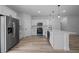 Modern kitchen with white cabinetry, stainless steel appliances, and center island with a sink and stylish pendant lights at 3978 Sw 151St St, Ocala, FL 34473