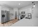 Well-lit kitchen showcases stainless steel appliances, sleek white cabinets, and a quartz countertop at 3978 Sw 151St St, Ocala, FL 34473