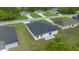 New home featuring a dark roof, minimalist white paint scheme, and a sliding glass door entry at 3978 Sw 151St St, Ocala, FL 34473