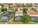 Aerial view of a neighborhood featuring screened-in pools, lush landscaping, and tile roofs at 4147 Oaktree Dr, Davenport, FL 33837