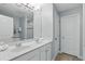 Bathroom featuring a double vanity, a large mirror, a shower, and a separate toilet room at 4147 Oaktree Dr, Davenport, FL 33837