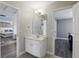 Hall bathroom featuring a single vanity, neutral paint, and doorways to bedrooms at 4147 Oaktree Dr, Davenport, FL 33837