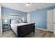 Cozy bedroom with soothing blue walls, comfortable bed, and modern decor at 4147 Oaktree Dr, Davenport, FL 33837