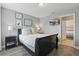 Comfortable bedroom features a large bed, modern decor, and attached ensuite at 4147 Oaktree Dr, Davenport, FL 33837