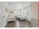 Charming bedroom features twin beds, decorative wallpaper, and a stylish chandelier at 4147 Oaktree Dr, Davenport, FL 33837