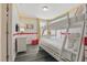 Cozy bedroom features a bunk bed, creative wallpaper, and ample natural light at 4147 Oaktree Dr, Davenport, FL 33837