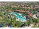 Birds eye view of a community pool with tropical landscaping, a clubhouse, and plentiful seating at 4147 Oaktree Dr, Davenport, FL 33837