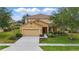 Charming two-story home with manicured lawn, beautiful landscaping, and neutral color palette at 4147 Oaktree Dr, Davenport, FL 33837