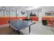 Spacious game room features a ping pong table, foosball table and Harry Potter-themed wall decor at 4147 Oaktree Dr, Davenport, FL 33837