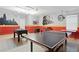 Recreation room features a ping pong table, foosball table, and playful mural at 4147 Oaktree Dr, Davenport, FL 33837