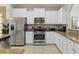 A well-appointed kitchen with stainless steel appliances and granite countertops at 4147 Oaktree Dr, Davenport, FL 33837