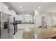 Open kitchen with stainless steel appliances, granite counters and breakfast bar seating at 4147 Oaktree Dr, Davenport, FL 33837