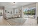 Comfortable living room with a sectional sofa, modern lighting, and sliding glass doors leading to a screened pool area at 4147 Oaktree Dr, Davenport, FL 33837