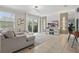 Stylish living room featuring a TV, a modern console, and sliding glass doors offering access to an outdoor space at 4147 Oaktree Dr, Davenport, FL 33837