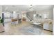 Open-concept space showcasing a kitchen with seating and a living area with a sectional sofa and contemporary decor at 4147 Oaktree Dr, Davenport, FL 33837