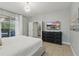 Comfortable main bedroom features a king bed, dresser, and sliding glass doors that access a screened outdoor living space at 4147 Oaktree Dr, Davenport, FL 33837