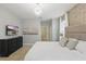 Main bedroom with a king bed, dresser, designer lighting, and access to an ensuite bathroom at 4147 Oaktree Dr, Davenport, FL 33837