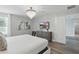 Bright main bedroom featuring a sleek chandelier and a view of the connected bathroom at 4147 Oaktree Dr, Davenport, FL 33837