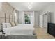 Main bedroom showcasing a king bed, soft lighting, and sliding glass doors leading to a screened outdoor area at 4147 Oaktree Dr, Davenport, FL 33837