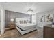 Elegant bedroom featuring a unique wallpaper accent wall and decorative chandelier at 4147 Oaktree Dr, Davenport, FL 33837