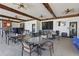 Outdoor seating area with ceiling fans, multiple tables, and a television creates a comfortable space at 4147 Oaktree Dr, Davenport, FL 33837