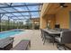 Screened-in pool and hot tub with patio furniture for lounging and outdoor dining at 4147 Oaktree Dr, Davenport, FL 33837