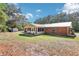 The back of the home features a brick exterior, a sunroom addition, and a metal roof at 42116 E Lakeview Dr, Altoona, FL 32702