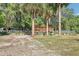 Backyard showcasing covered shelter with mature trees and landscaping at 42116 E Lakeview Dr, Altoona, FL 32702
