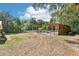 Backyard with an open shelter, trees, and well-maintained lawn at 42116 E Lakeview Dr, Altoona, FL 32702