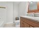 Bathroom featuring a granite-topped vanity and cabinet, toilet, and shower/tub combo at 42116 E Lakeview Dr, Altoona, FL 32702