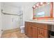 Bathroom with vanity, mirror, glass-enclosed shower, and tile flooring at 42116 E Lakeview Dr, Altoona, FL 32702