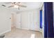 Bedroom featuring a window, fan and white closet doors at 42116 E Lakeview Dr, Altoona, FL 32702