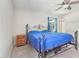 Bedroom with fan, window and metal bed frame at 42116 E Lakeview Dr, Altoona, FL 32702