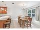 Charming dining area with a wooden table, chairs, and a window offering natural light at 42116 E Lakeview Dr, Altoona, FL 32702