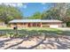 Charming single-story brick home with a well-manicured front lawn and a metal roof at 42116 E Lakeview Dr, Altoona, FL 32702