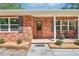 Inviting front porch with brick facade, rocking chairs, and tasteful landscaping at 42116 E Lakeview Dr, Altoona, FL 32702