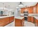 Spacious kitchen featuring a center island, granite countertops, and custom wood cabinetry at 42116 E Lakeview Dr, Altoona, FL 32702