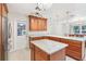 Bright kitchen with granite counters, wood cabinets and island with stainless steel appliances at 42116 E Lakeview Dr, Altoona, FL 32702
