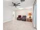 The living room with neutral flooring, ceiling fan, and a warm lamp on an end table at 42116 E Lakeview Dr, Altoona, FL 32702