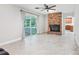 Bright living area featuring a brick fireplace, sliding glass doors and neutral flooring at 42116 E Lakeview Dr, Altoona, FL 32702