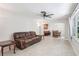 Spacious living room featuring tile floors, a ceiling fan, and a bar area at 42116 E Lakeview Dr, Altoona, FL 32702