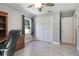 Office space with white bi-fold closet doors, tile floors, and a window letting in natural light at 42116 E Lakeview Dr, Altoona, FL 32702