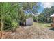 Backyard view of a storage shed and its surrounding landscape at 42116 E Lakeview Dr, Altoona, FL 32702