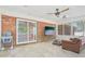 Bright sunroom featuring brick walls, tile floors, a ceiling fan, and backyard views at 42116 E Lakeview Dr, Altoona, FL 32702