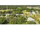 Picturesque aerial view of homes near a golf course, blending community living with recreational charm at 4349 River Ridge Dr, Leesburg, FL 34748