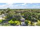 Aerial view of a well-maintained property surrounded by lush greenery and mature trees at 4349 River Ridge Dr, Leesburg, FL 34748