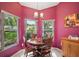 Features a cozy dining area with multiple windows, a wood table, and vintage furnishings at 4349 River Ridge Dr, Leesburg, FL 34748