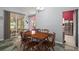 Open dining room featuring a farmhouse table, chairs, and slider doors for seamless indoor and outdoor living at 4349 River Ridge Dr, Leesburg, FL 34748