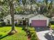 Charming single-story home with a well-maintained lawn, mature trees, and a patterned driveway leading to a two-car garage at 4349 River Ridge Dr, Leesburg, FL 34748